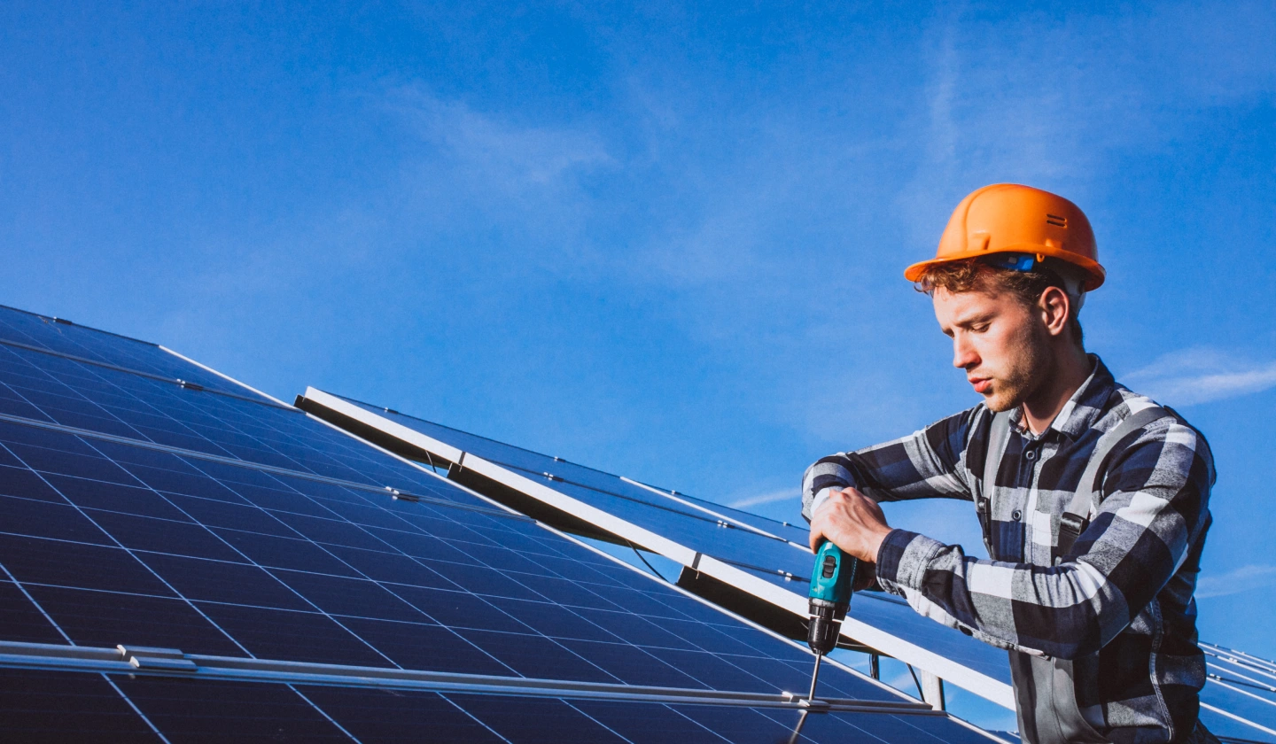 Instalador atornillando la estructura de soporte de unos paneles solares